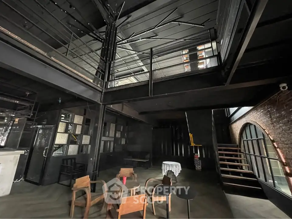 Industrial-style loft with modern furniture and exposed brick walls, perfect for creative living or workspace.