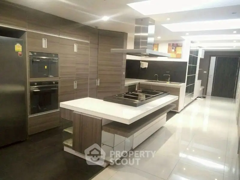 Luxurious modern kitchen with sleek cabinetry and island in upscale home.