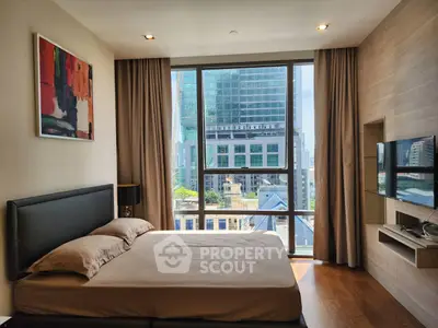 Modern bedroom with city view, featuring large windows and stylish decor.