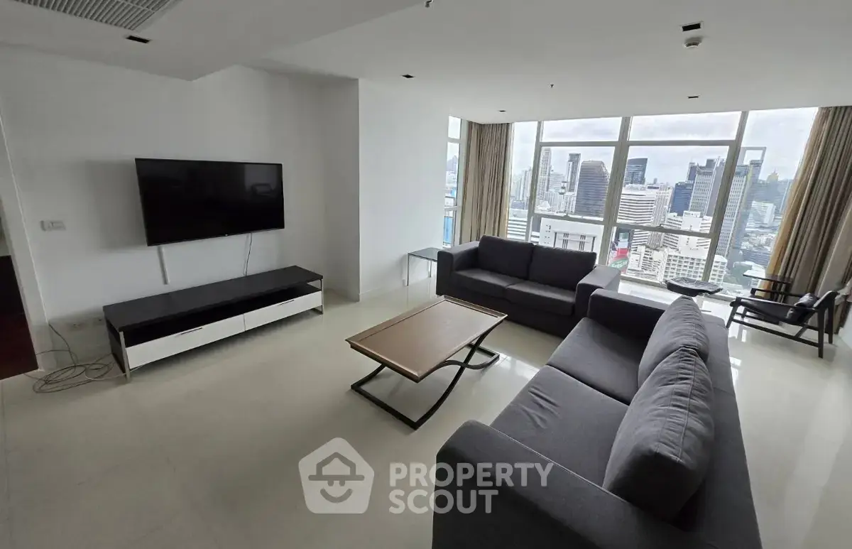 Spacious living room with modern furniture and stunning city view