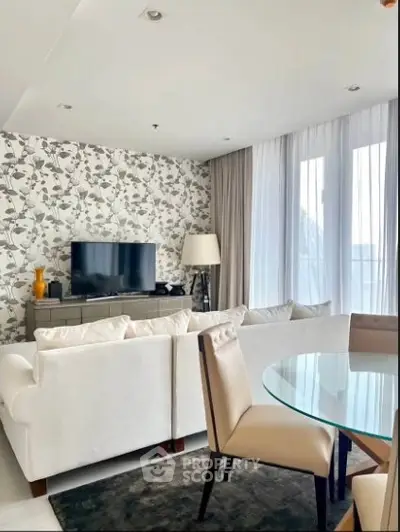 Elegant living room with modern decor and large windows offering natural light.
