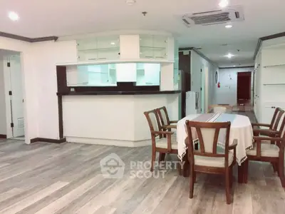 Spacious open-plan living area with modern kitchen and dining set