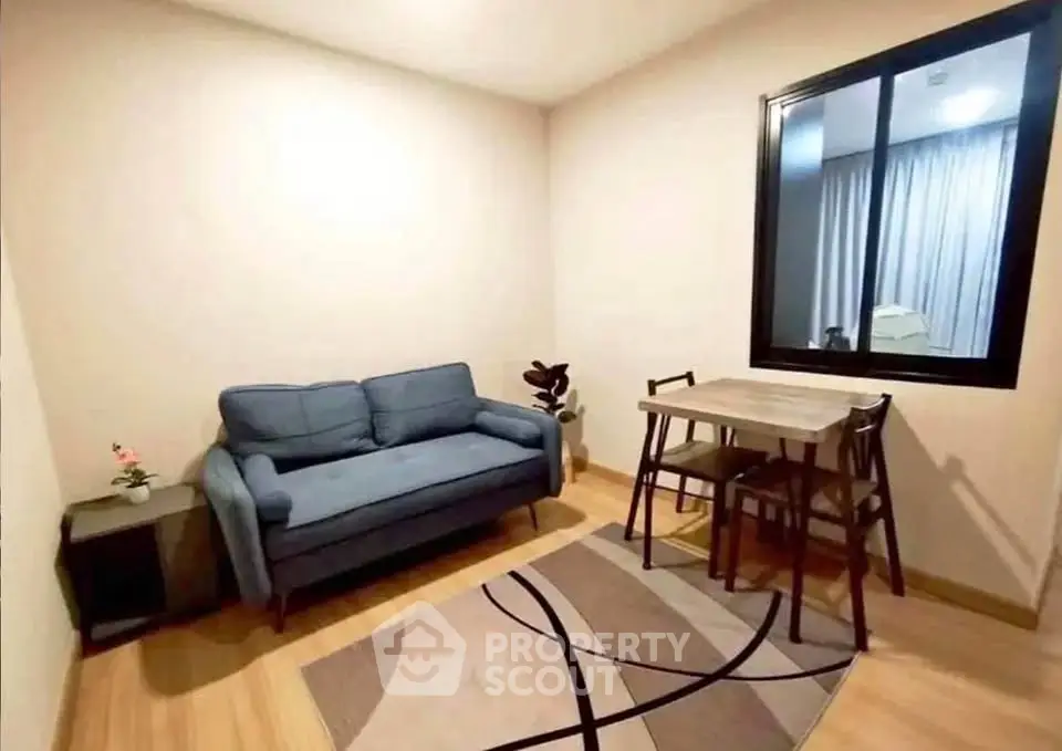 Cozy living room with modern sofa and dining table, perfect for small apartments.
