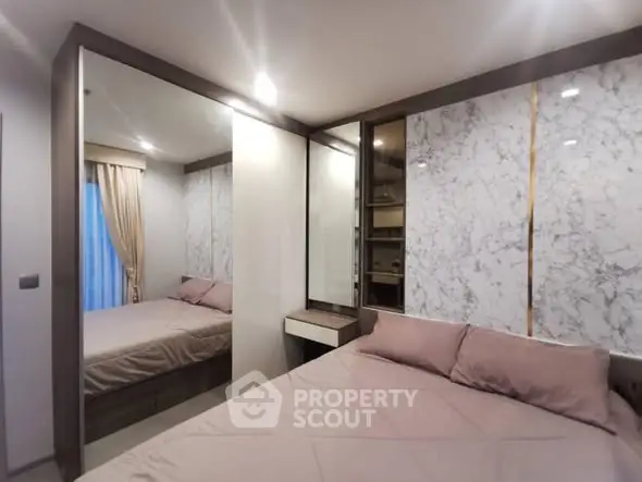 Modern bedroom with mirrored closet and elegant marble accents