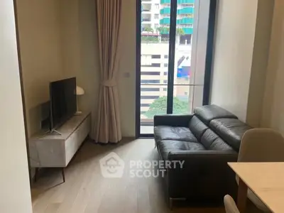 Modern living room with sleek leather sofa and large window offering city view.