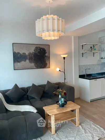 Chic living room with modern decor, cozy sofa, and stylish lighting in a contemporary apartment.