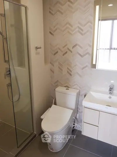 Modern bathroom with sleek shower and stylish vanity in contemporary design.