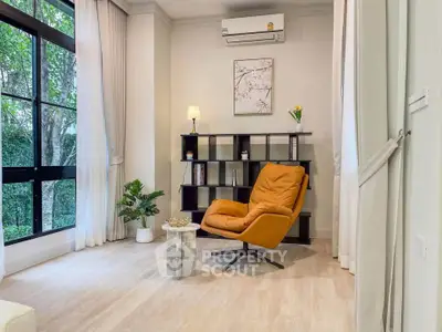 Stylish living room with modern armchair and large window view