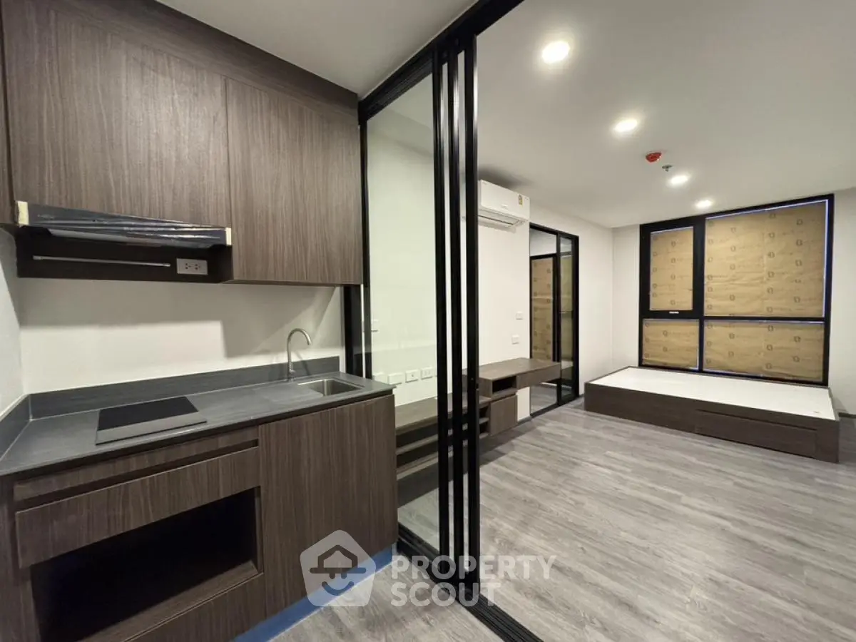 Modern studio apartment with sleek kitchen and spacious layout