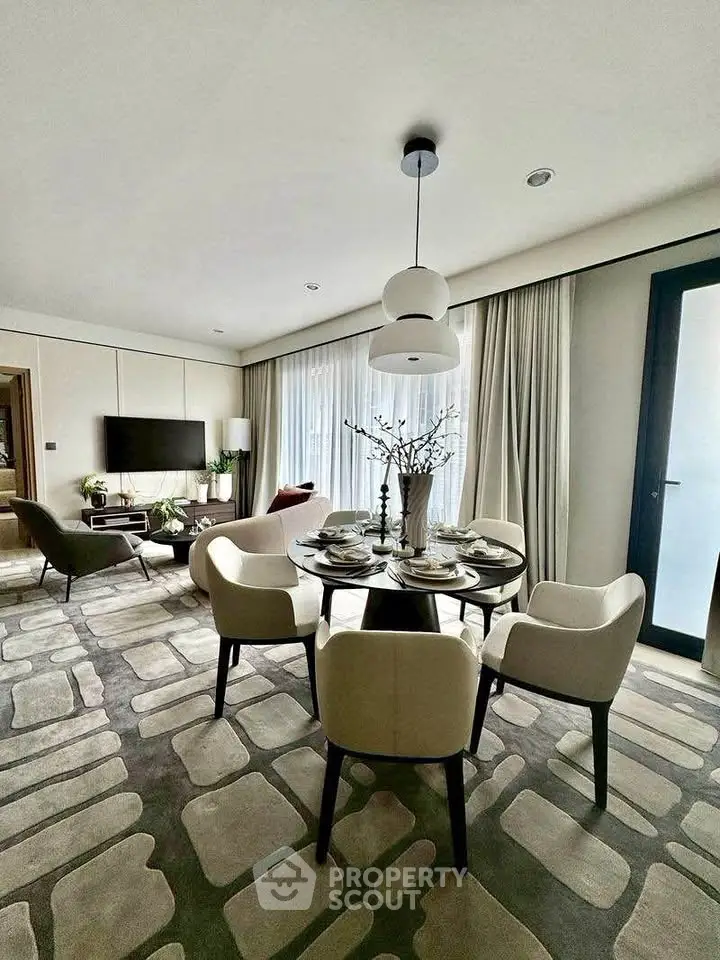 Elegant modern living room with dining area, stylish furniture, and large windows for natural light.