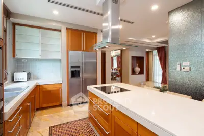 Luxurious modern kitchen with island and stainless steel appliances in open layout
