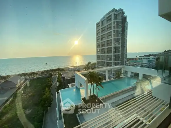 Stunning oceanfront view from luxury condo with infinity pool at sunset