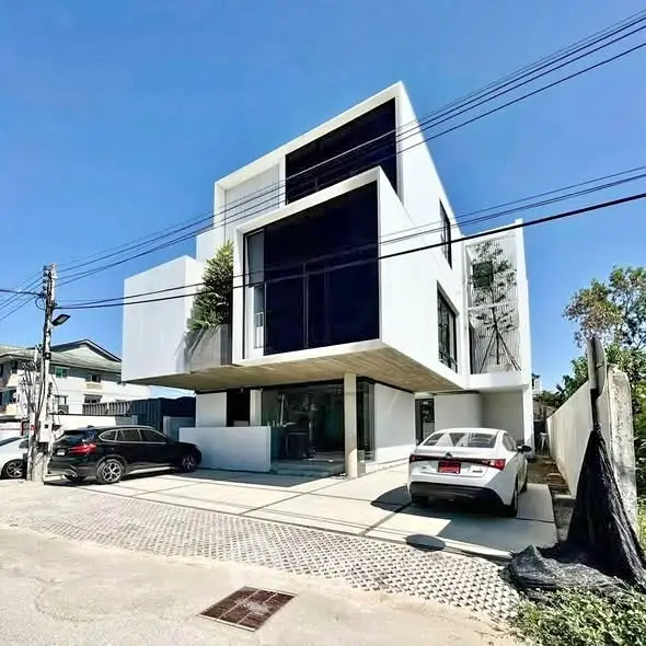 Modern architectural masterpiece with sleek design and spacious parking area, perfect for contemporary living.