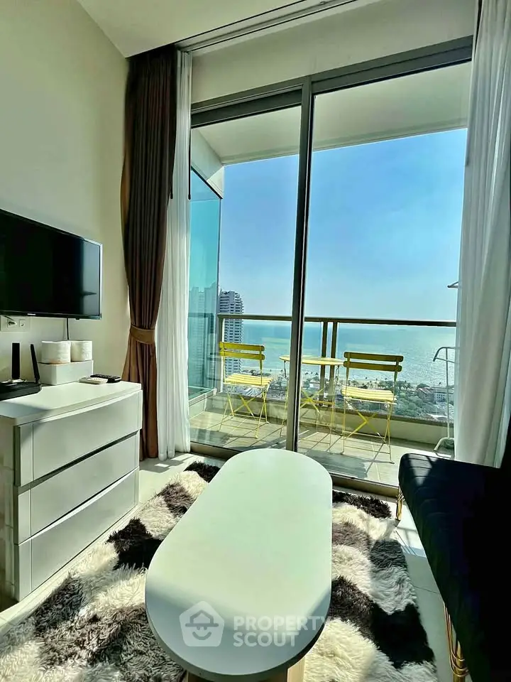 Modern living room with stunning ocean view and balcony access