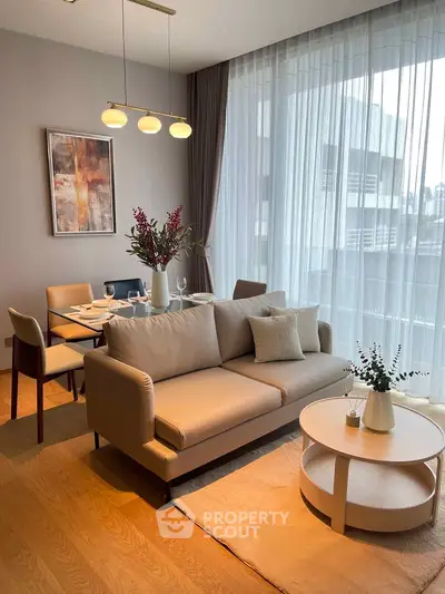 Elegant living room with modern furniture and large windows in a stylish apartment.