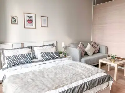 Cozy bedroom with stylish decor and comfortable seating area