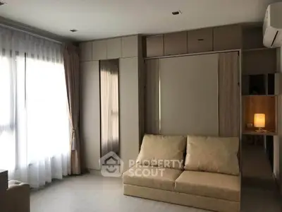 Modern living room with sleek furniture and ample natural light