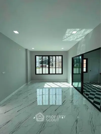 Spacious modern living room with marble flooring and large windows