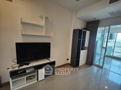 Modern living room with TV stand and shelves, featuring large windows and city view.