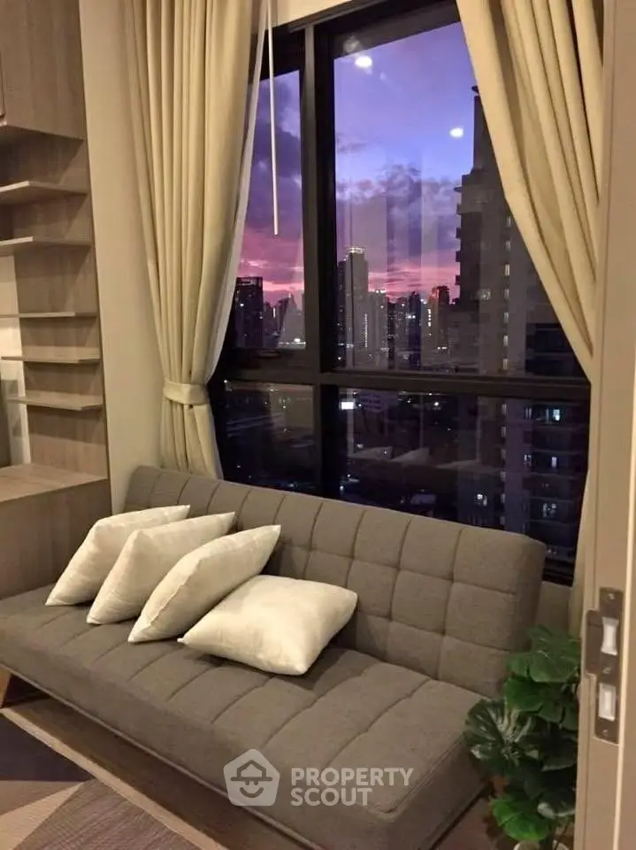 Chic living room with city skyline view at sunset, featuring modern sofa and elegant curtains.