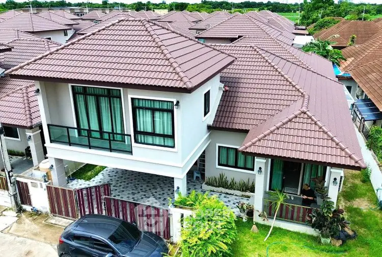 Charming two-story house with tiled roof and lush garden in a serene neighborhood.