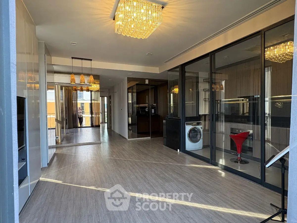 Spacious modern living area with elegant lighting and glass partition