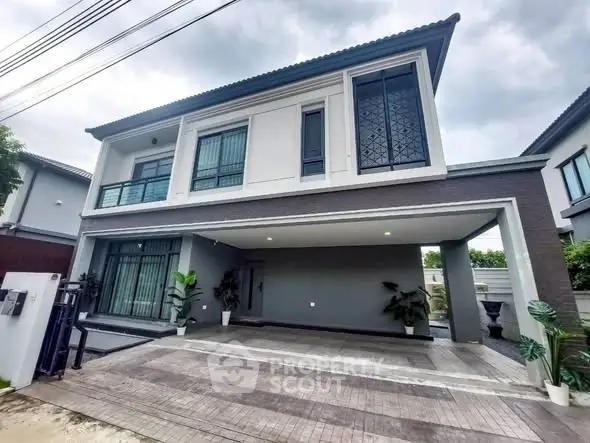 Modern two-story house with spacious driveway and elegant facade
