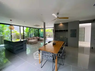 Spacious modern living room with open kitchen and garden view