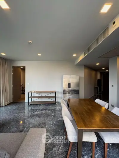 Elegant dining area with marble flooring and modern decor in a luxury apartment.
