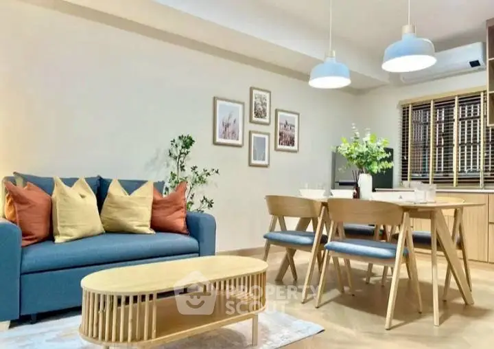 Modern living room with stylish furniture and cozy dining area, perfect for family gatherings.