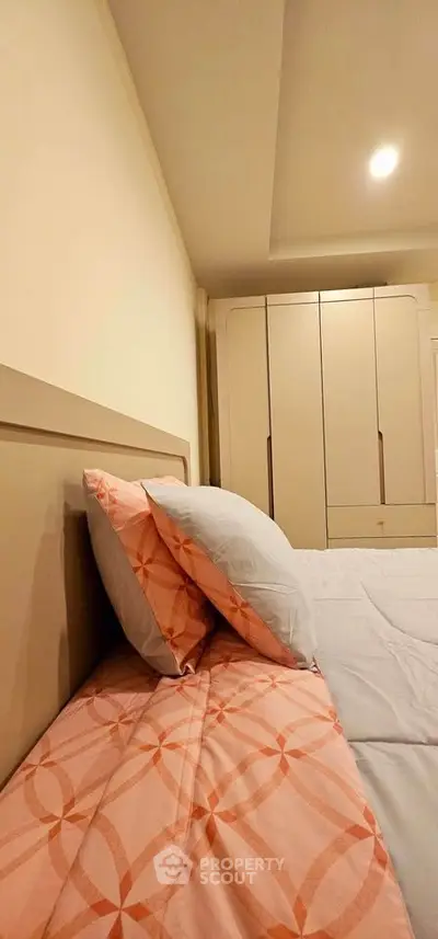 Cozy bedroom with stylish wardrobe and modern bedding