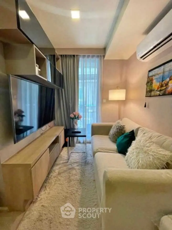 Cozy modern living room with plush sofa, large TV, and elegant decor