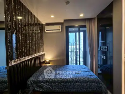 Modern bedroom with stylish decor and city view balcony access.