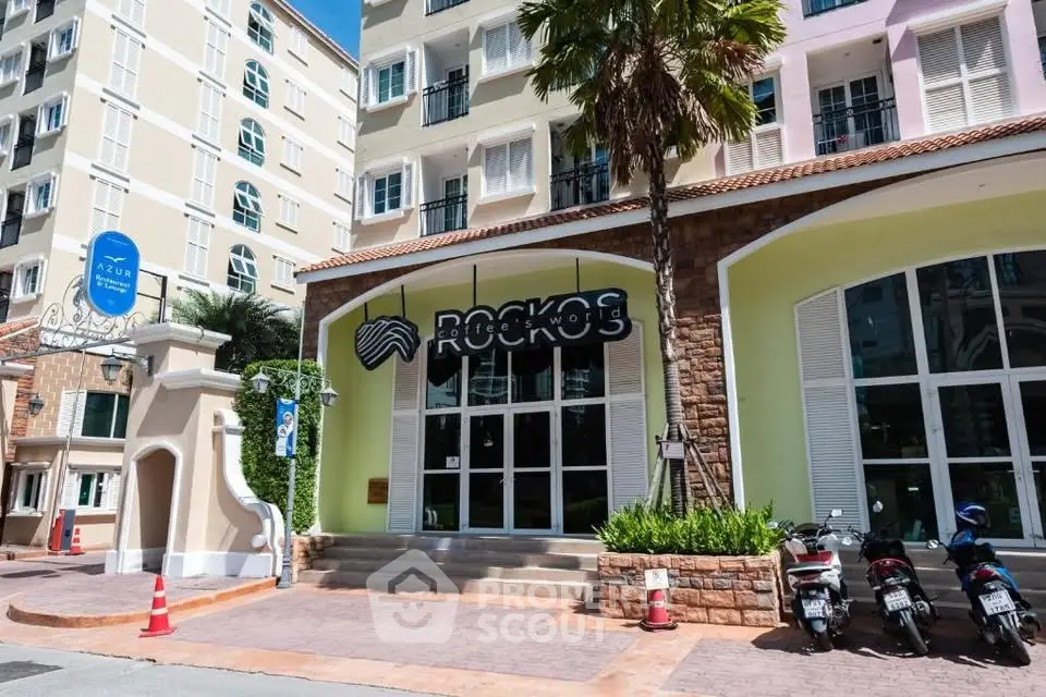 Charming building entrance with modern design and lush greenery, perfect for urban living.