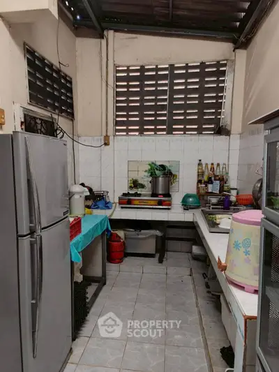 Cozy kitchen with gas stove and ample storage space, perfect for culinary enthusiasts.