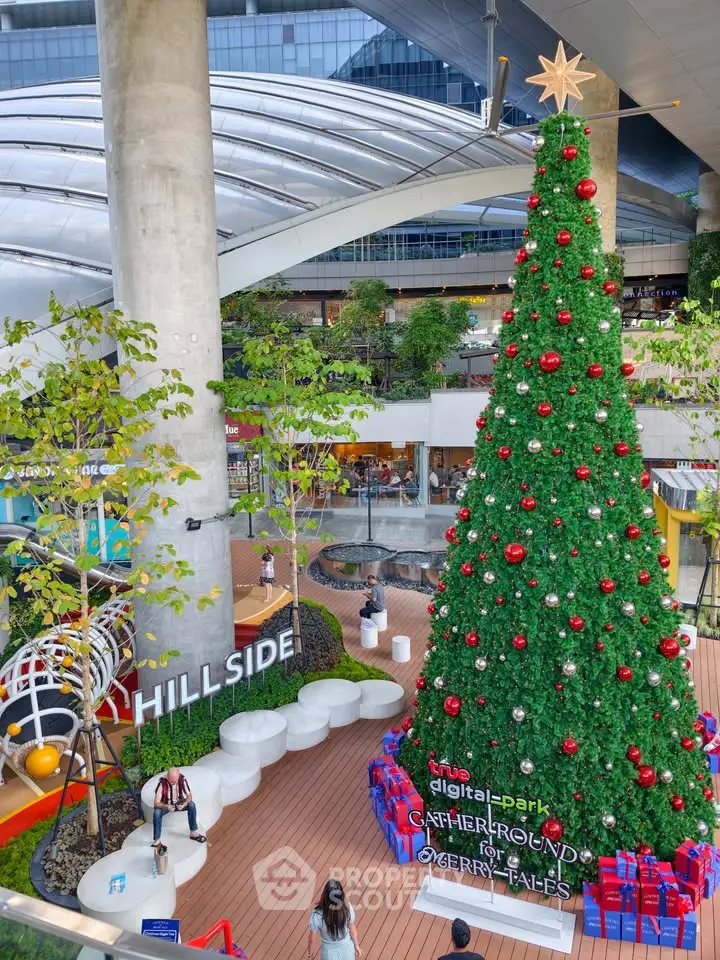 Stunning commercial space with festive decorations and towering Christmas tree, perfect for holiday shopping and gatherings.