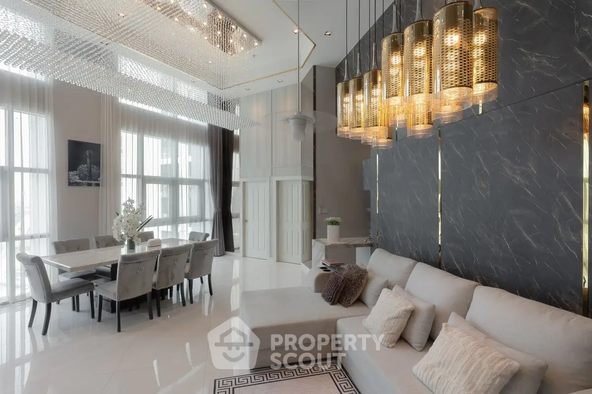 Luxurious modern living room with high ceilings and elegant chandelier