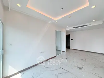 Spacious modern living room with marble flooring and recessed lighting