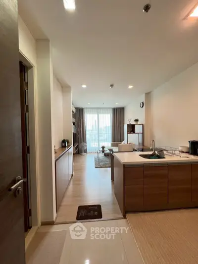 Spacious open-layout kitchen and living room with modern design and natural light.