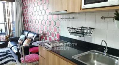 Chic kitchen with modern appliances and stylish living area in open layout apartment.
