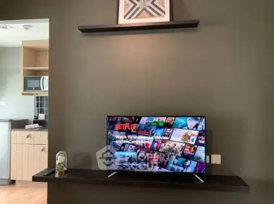 Modern living room with wall-mounted TV and stylish decor