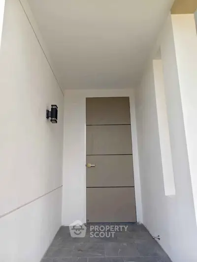 Modern minimalist entrance with sleek door and clean lines