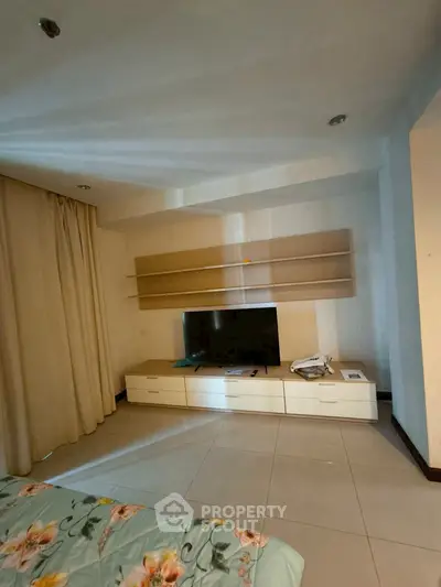 Cozy bedroom with modern TV unit and floral bedding