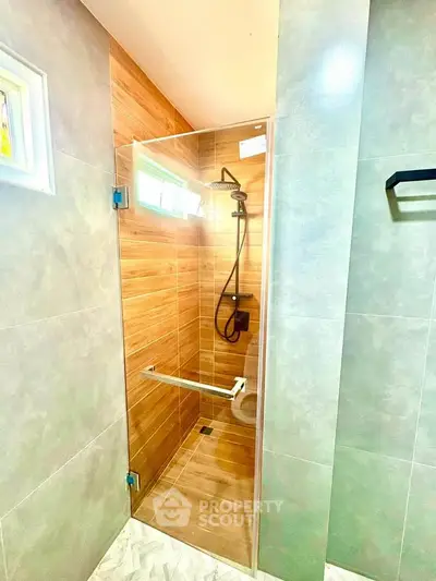 Modern bathroom with glass shower enclosure and stylish tile design