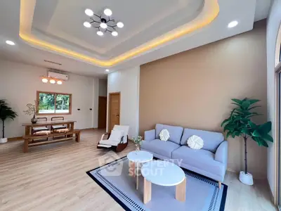 Spacious modern living room with elegant lighting and cozy seating area, perfect for relaxation and entertaining.