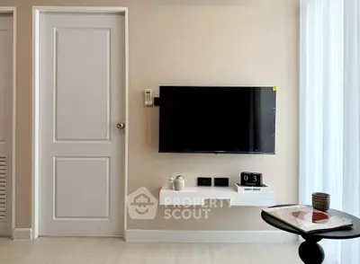 Modern living room with wall-mounted TV and minimalist decor