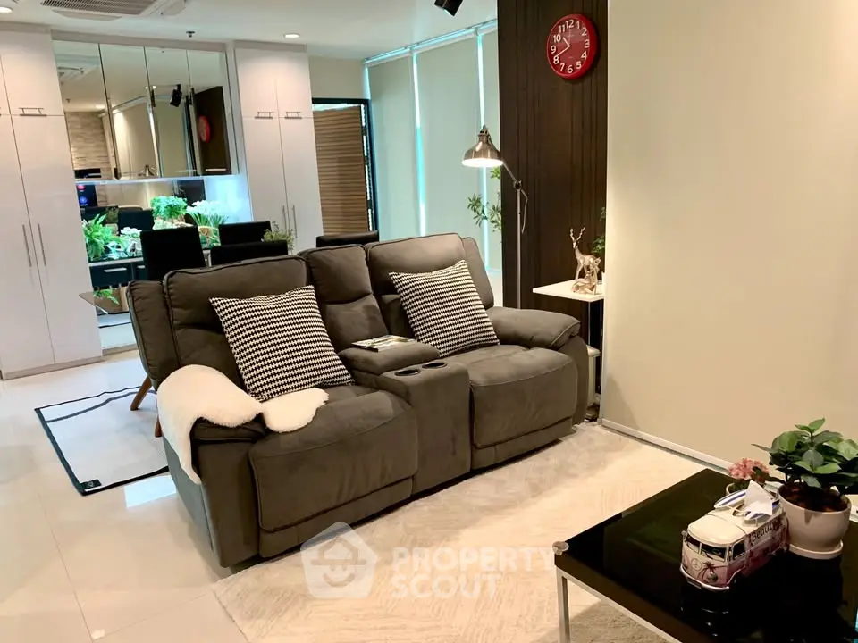 Modern living room with cozy seating and stylish decor in a contemporary apartment.