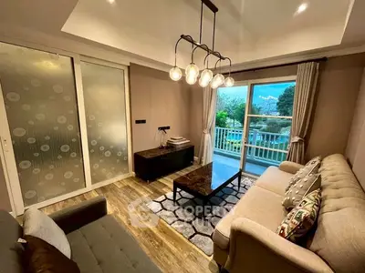 Charming living room with elegant lighting and balcony view