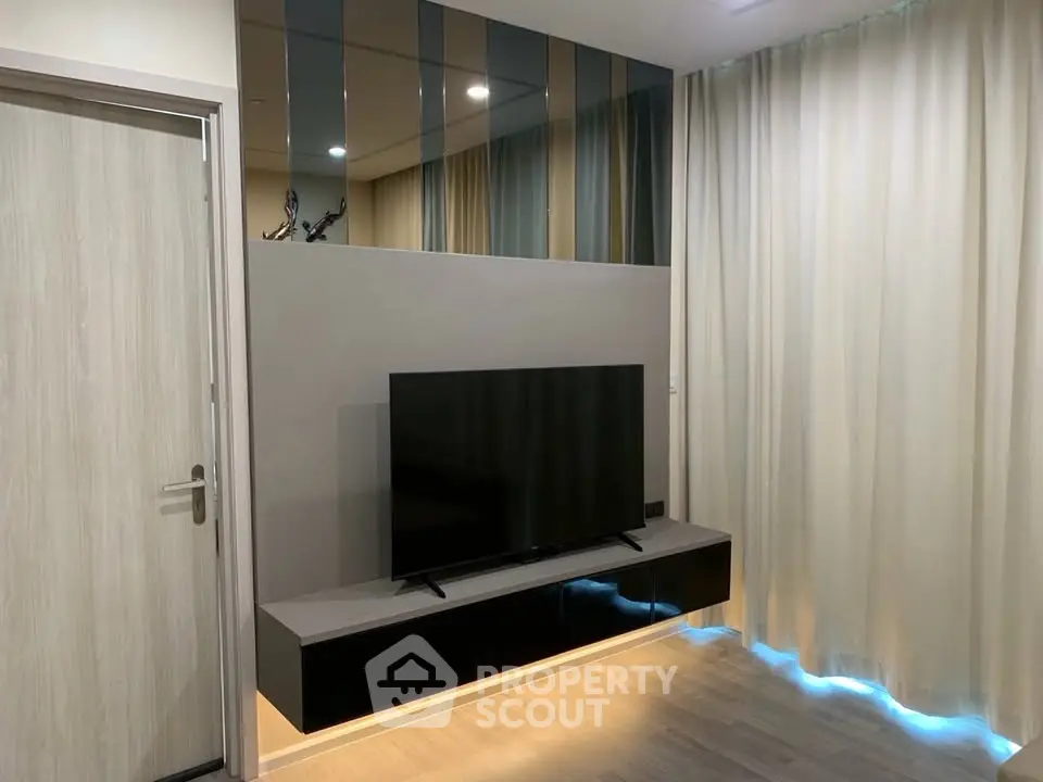 Modern living room with sleek TV setup and elegant curtains