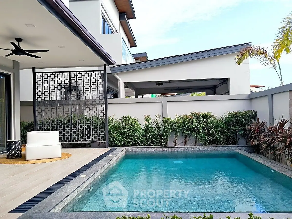 Luxurious modern home with private pool and stylish outdoor seating area, perfect for relaxation and entertainment.